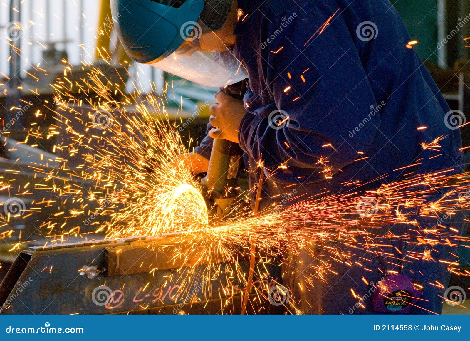 men at work grinding steel