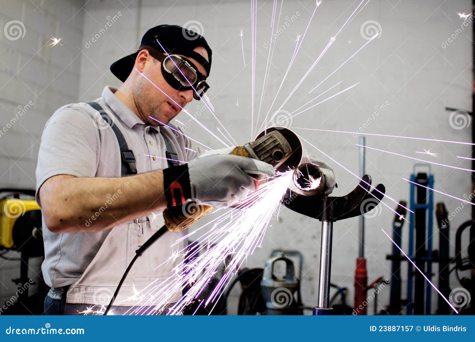 men at work grinding steel
