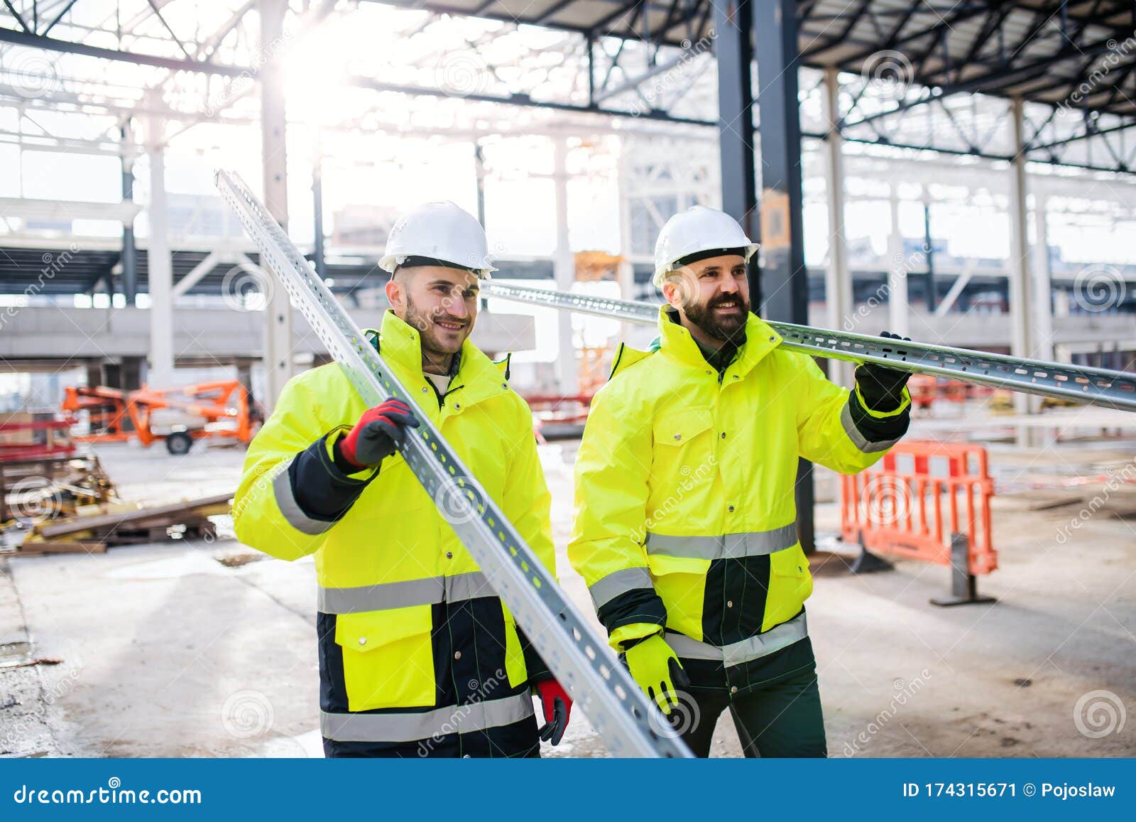 Men Workers Walking Outdoors on Construction Site, Working. Stock Image