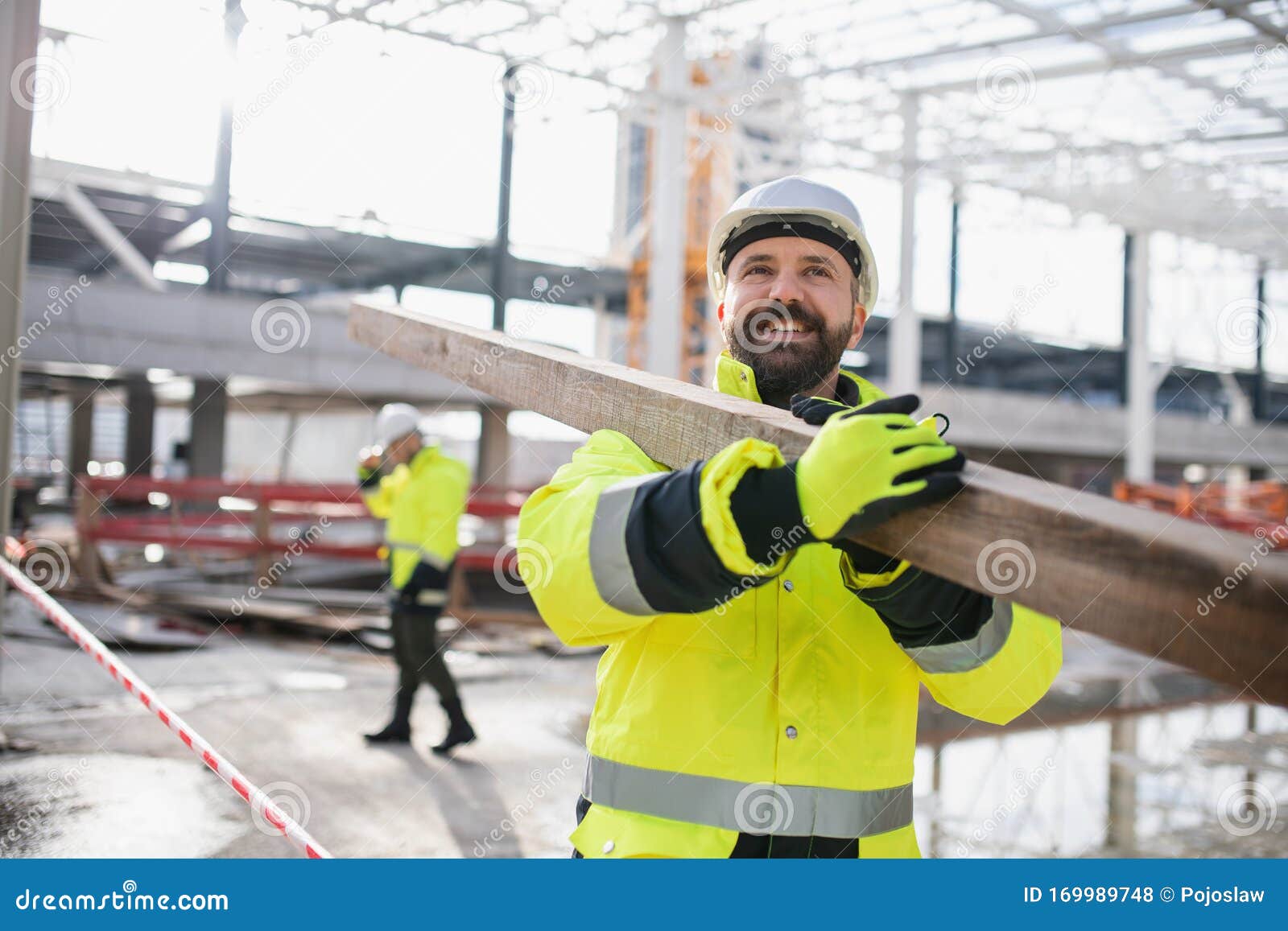 Men Workers Walking Outdoors on Construction Site, Working. Stock Photo