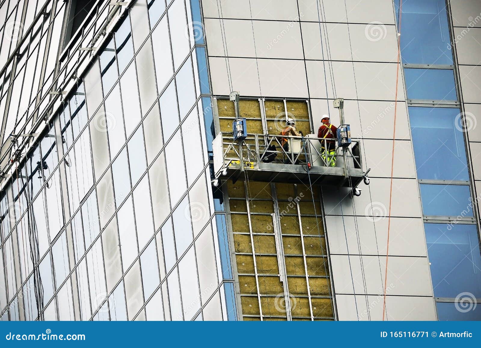 Men Working on Construction Lift Building Modern Glass Structure Stock