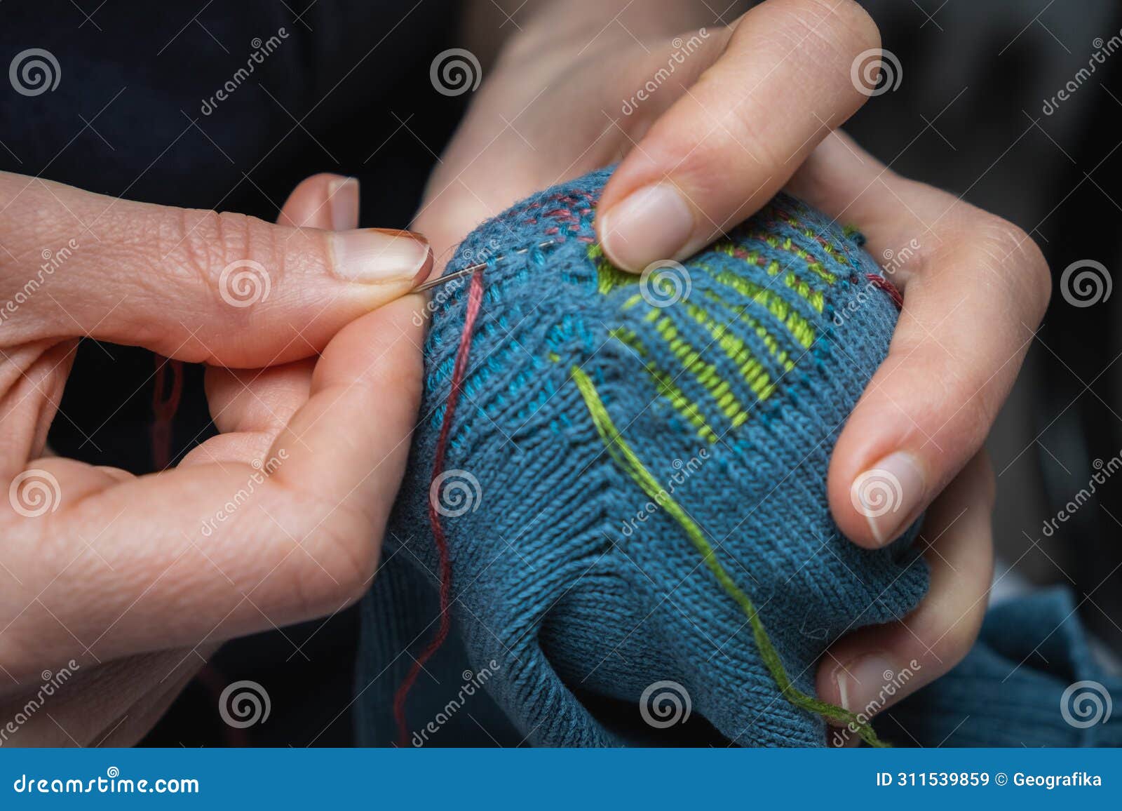 mending clothes. visible mending repairing sock
