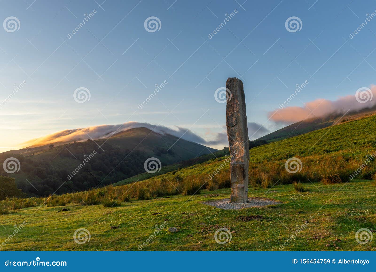 menhir of arlobi at sunset, gorbea natural park, alava, spain