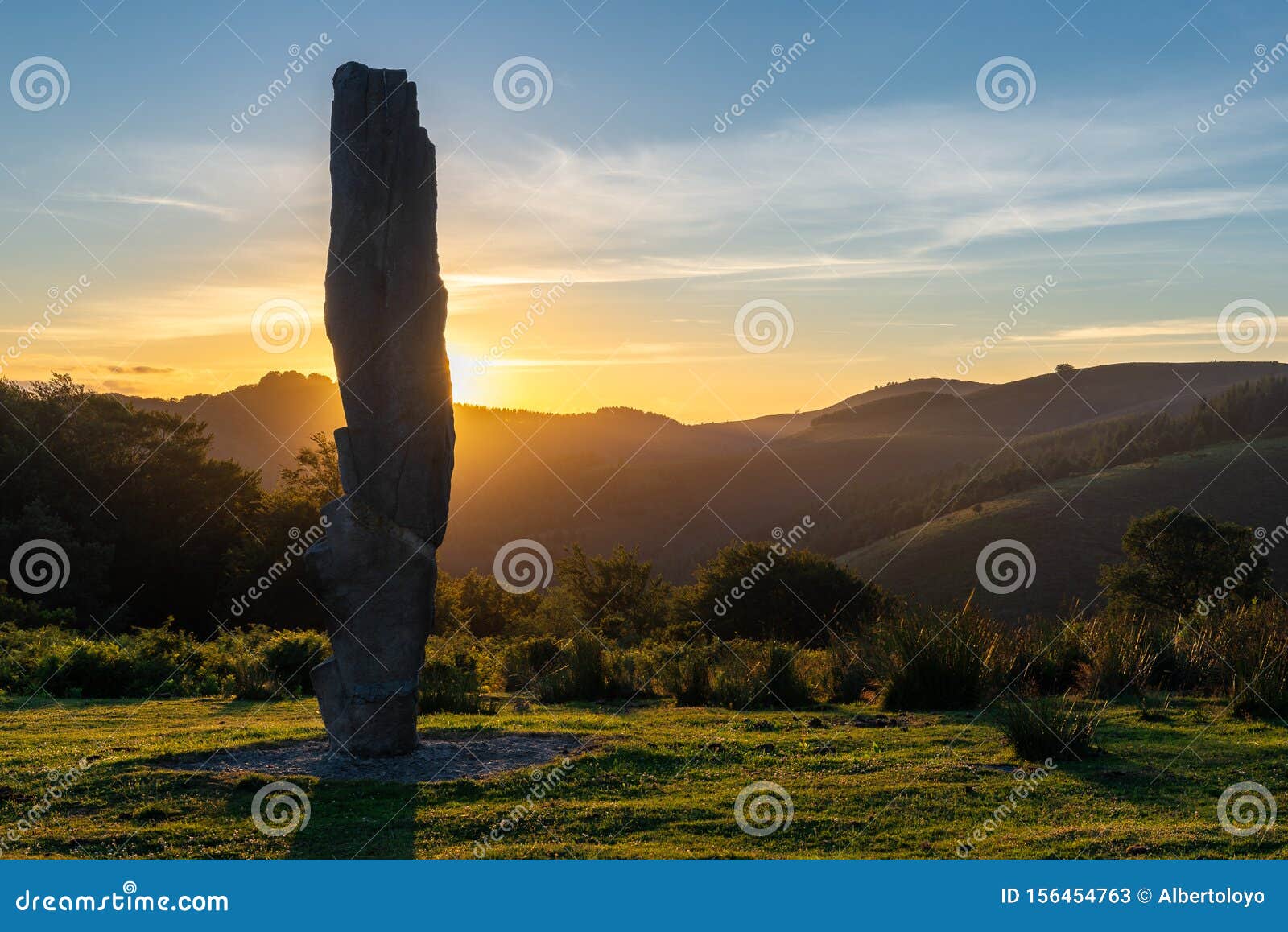 menhir of arlobi at sunset, gorbea natural park, alava, spain