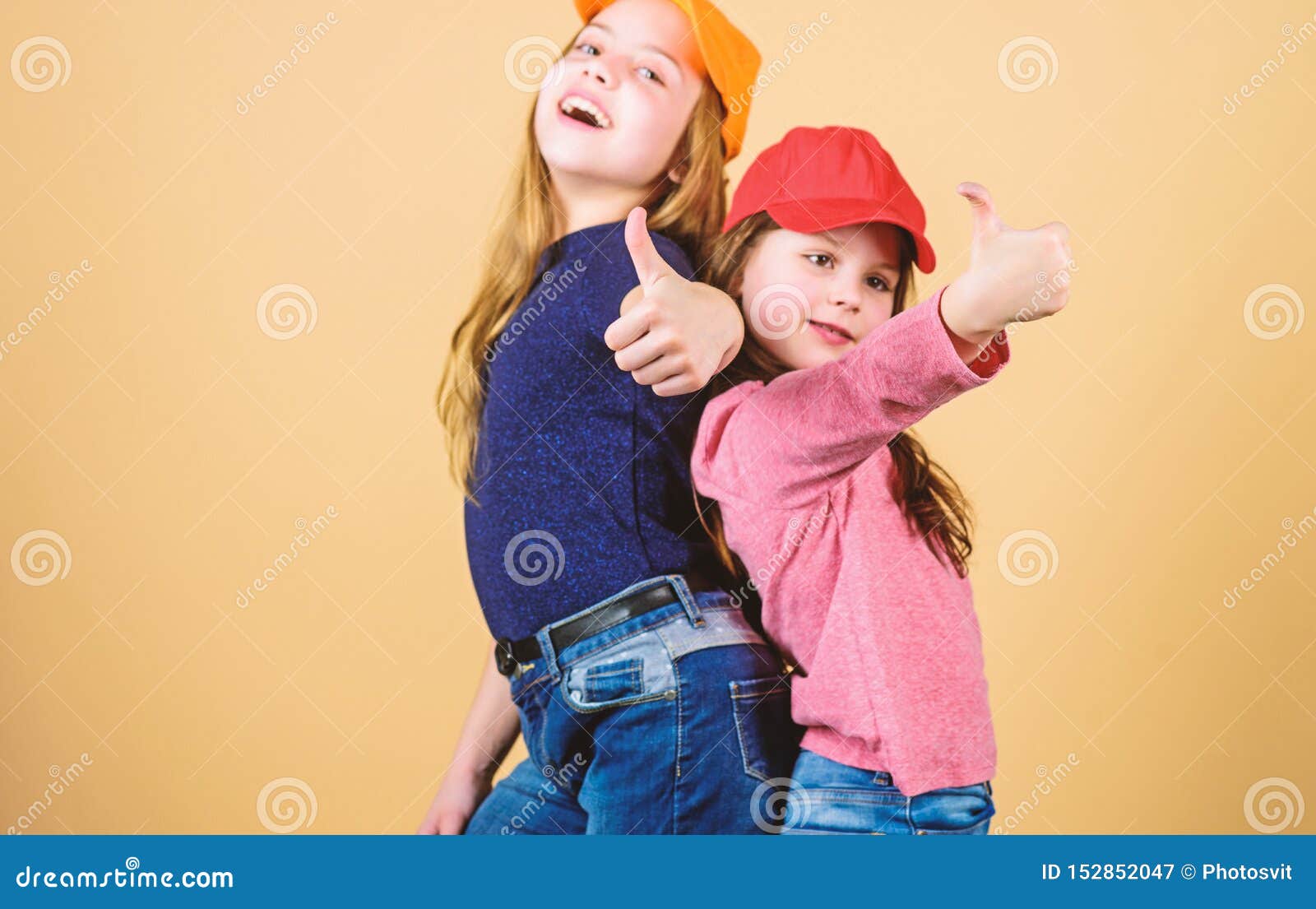 Cool Girls. Little Cute Girls Wearing Bright Baseball Caps. Modern ...