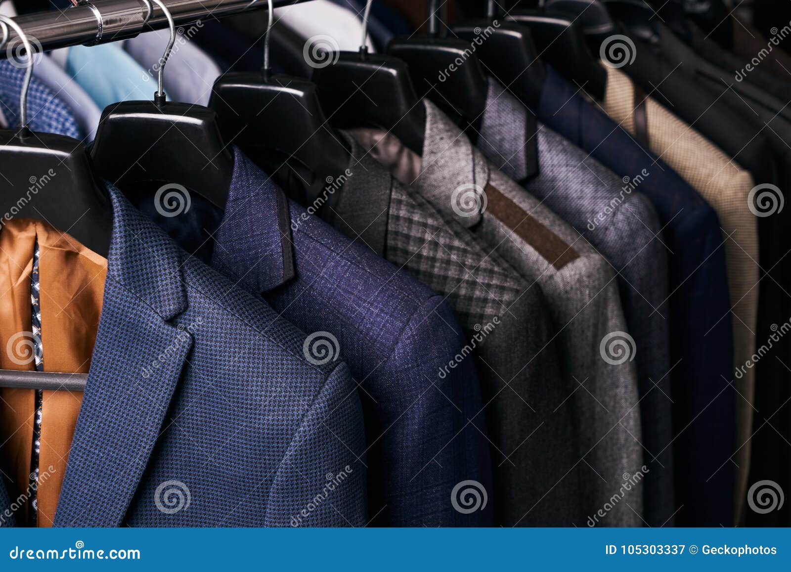 mens suits on hangers in different colors