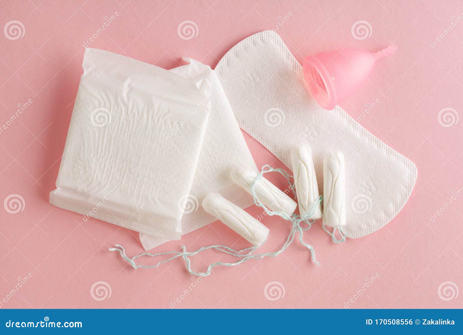 feminine hygiene and protection products, sanitary pads, tampons and menstrual cup on pastel pink background, top view, flat layou