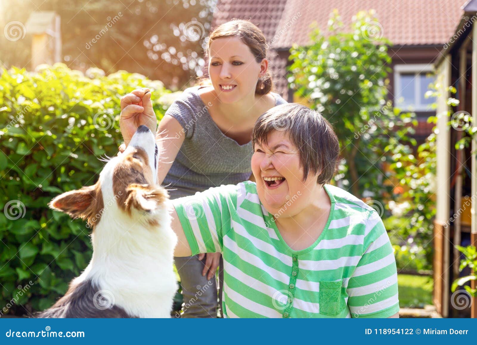 mentally disabled woman with a second woman and a companion dog