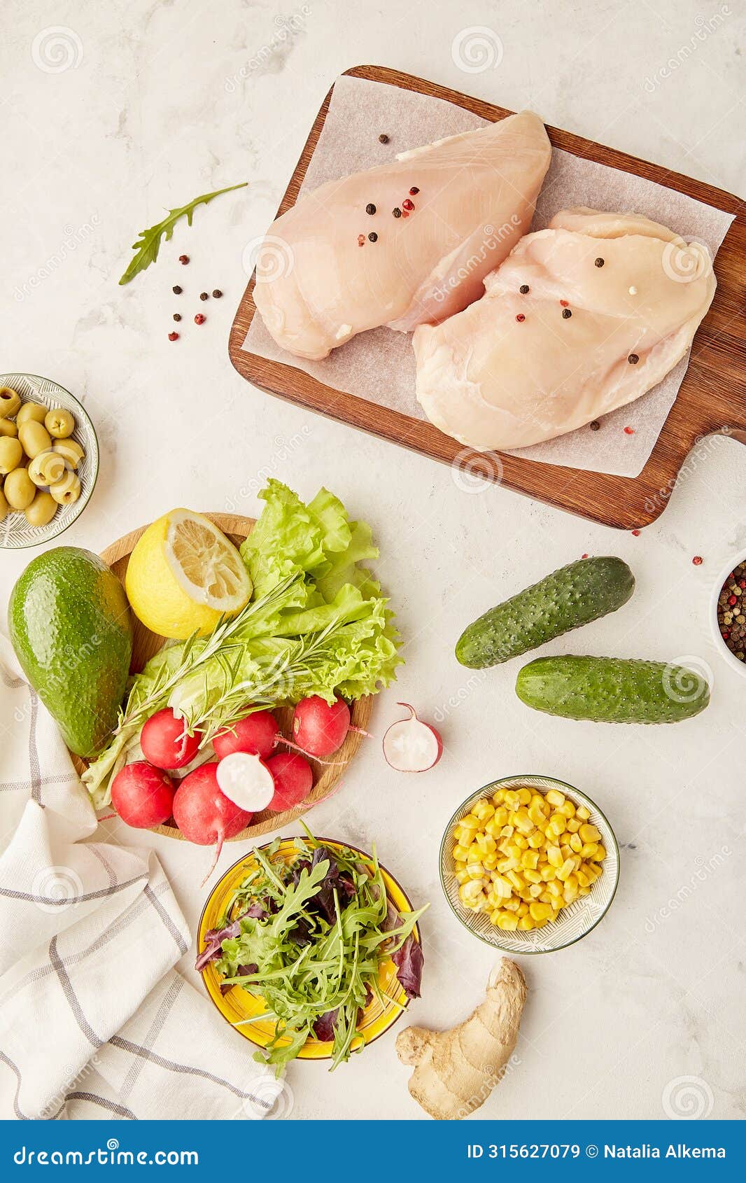 menu fot paleo, fodmap diet concept. fruits,vegetables, olives, chicken meat, greens on wooden cutting board.