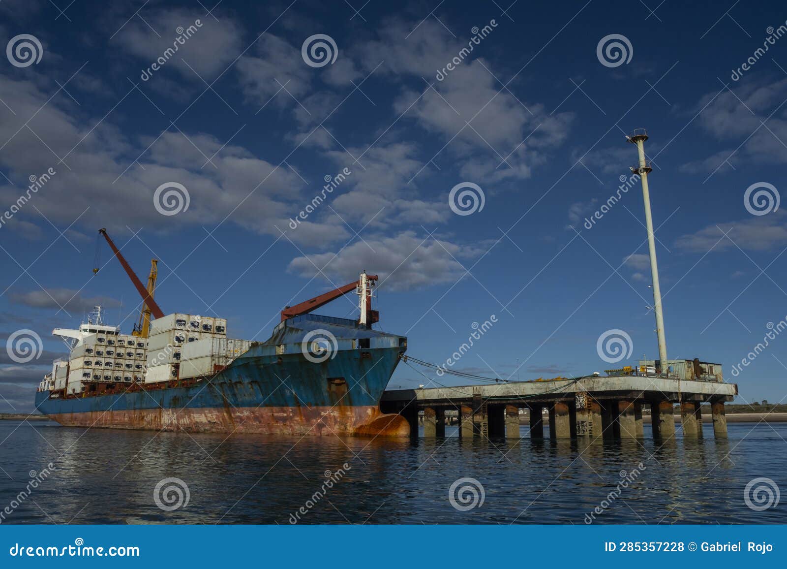 merchant ship moored in the port of san antonio este, rio negro