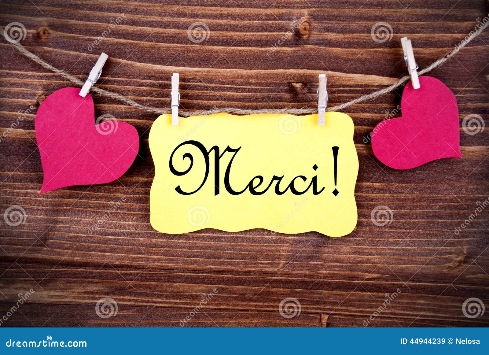 merci on a tag framed by hearts