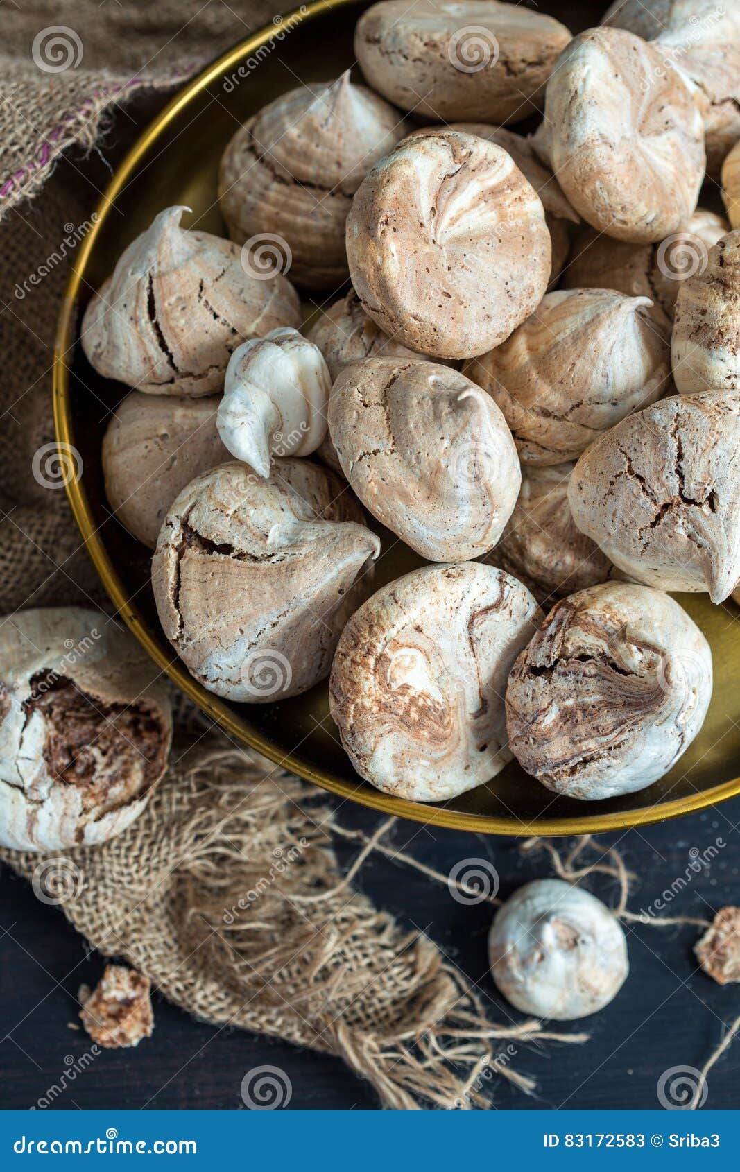 Meringue with Dark Chocolate on Bronze Tray Close Up. Stock Image