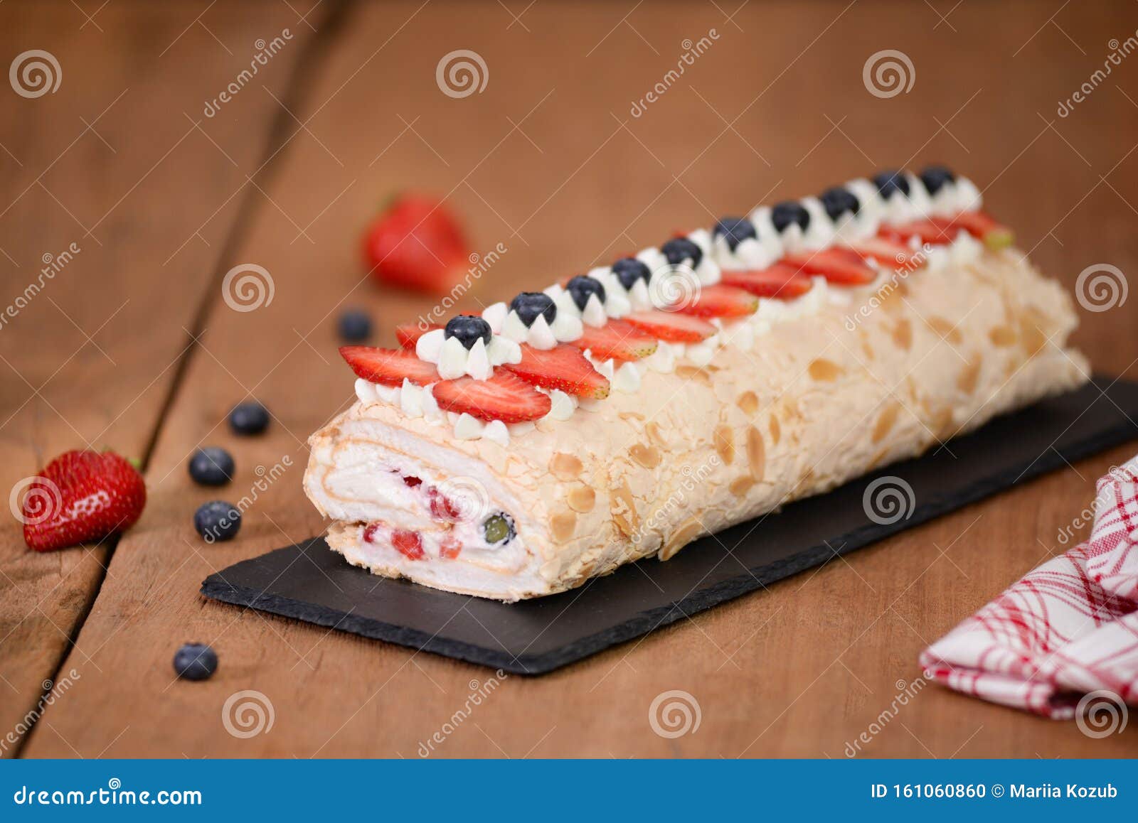 Meringue Roll Cake Decorated with Blueberries and Strawberries Stock