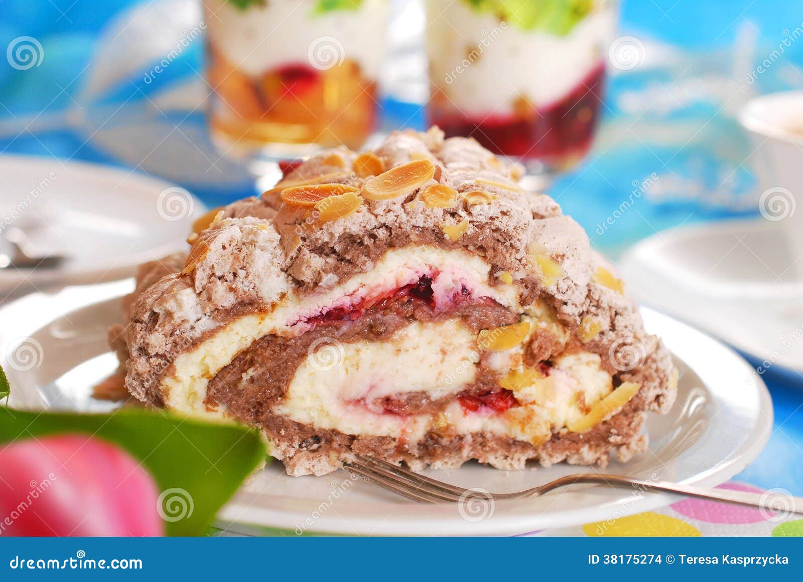 Meringue Swiss Roll Cake with Cherry Cream and Almonds Stock Photo