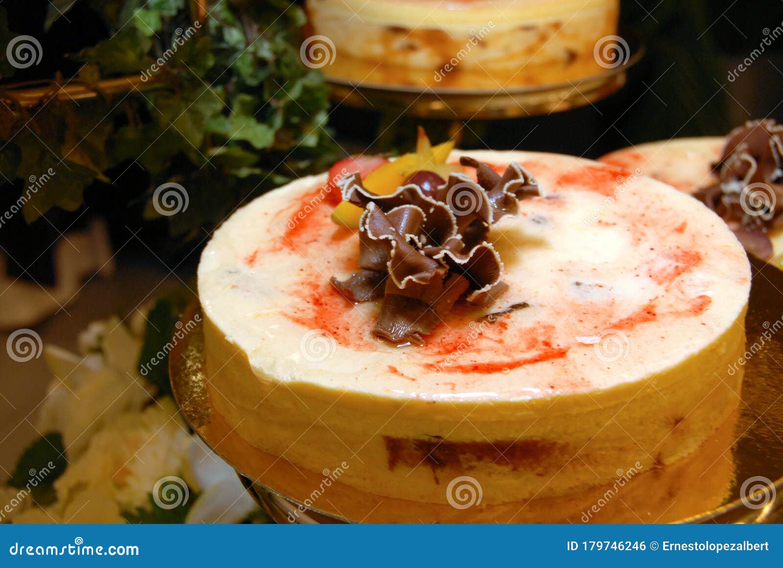Meringue Wedding Cake Decorated with Flowers Around it Stock Photo