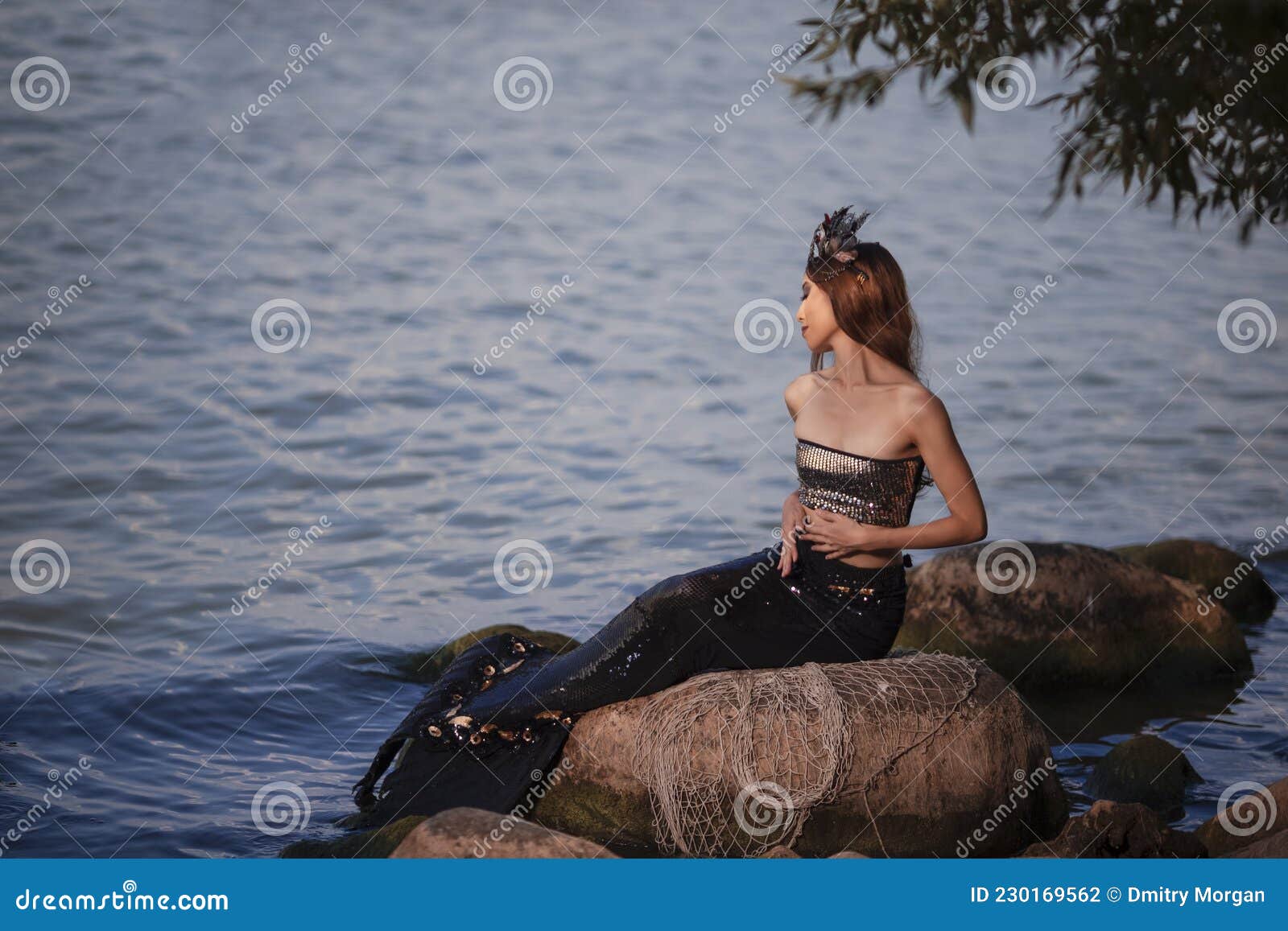 Mermaid Lady in Net at Sea Coast on Rocks Wearing Seashell