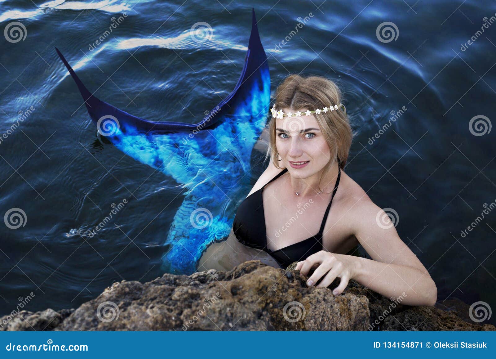 Mermaid Swims in the Water Peeking Out of the Rocks Stock Image ...
