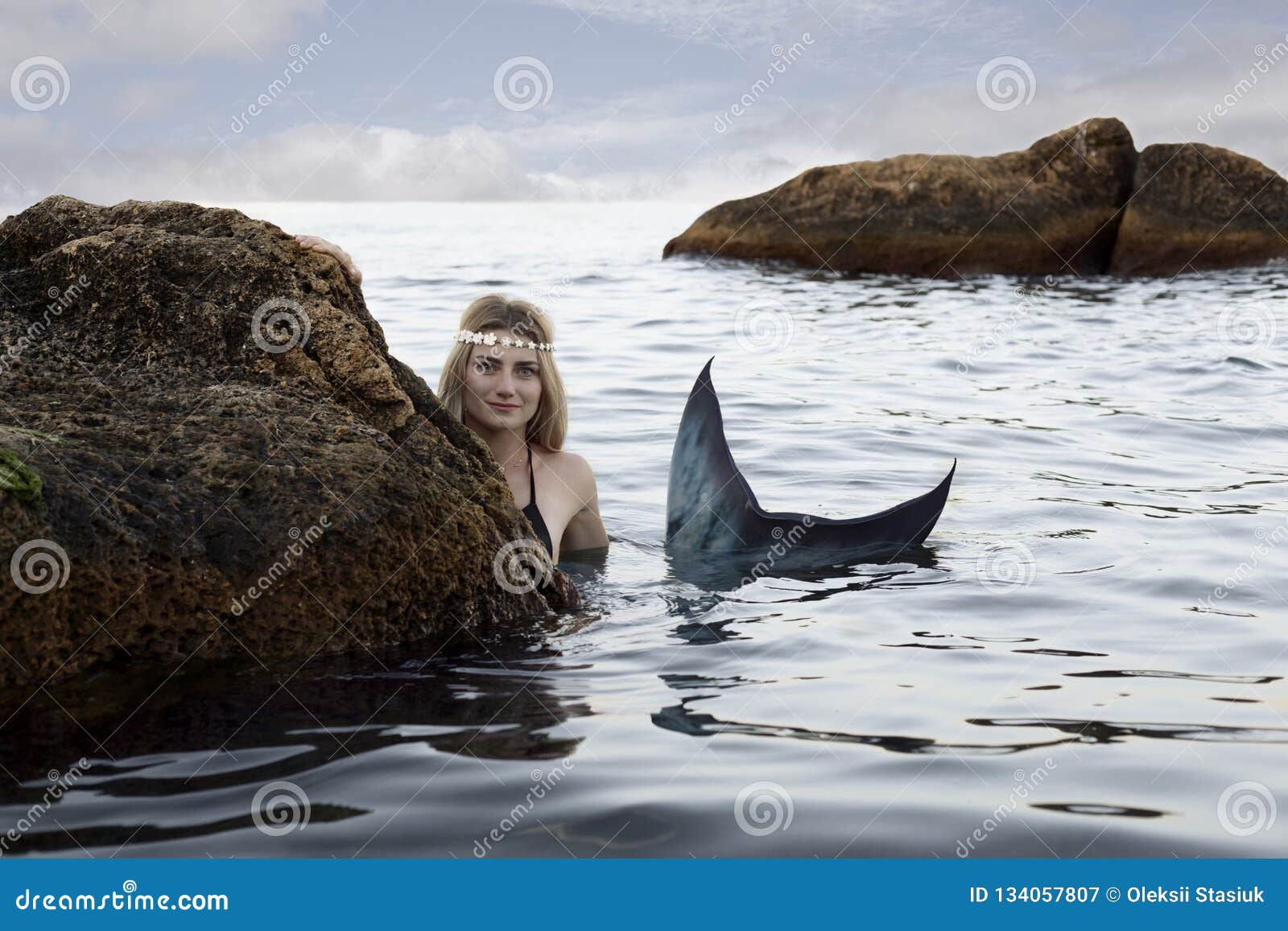 Mermaid Swims in the Water Peeking Out of the Rocks Stock Image ...