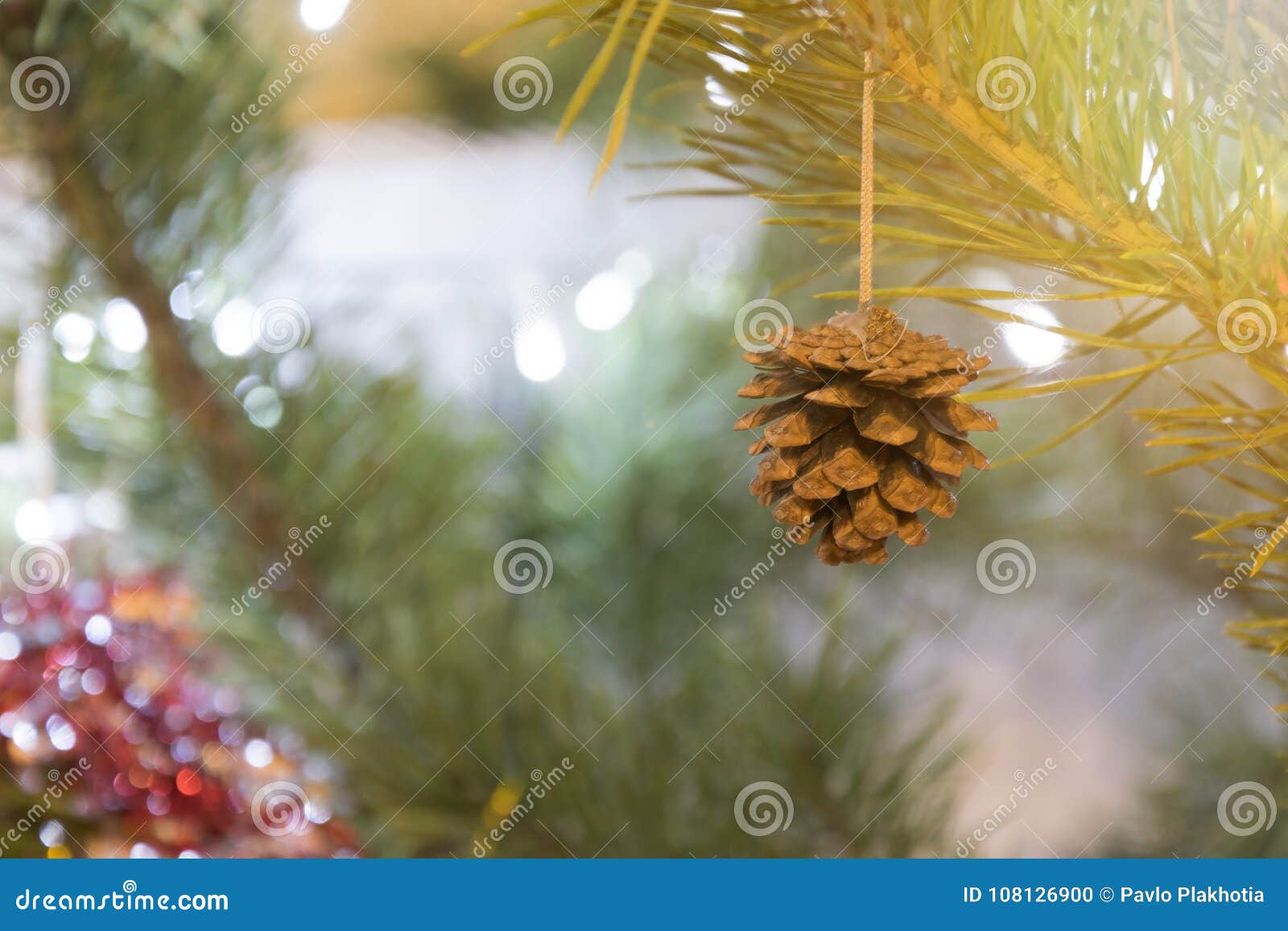 Merry Christmas Background. Cone on Decorated Pine Tree Closeup Over ...