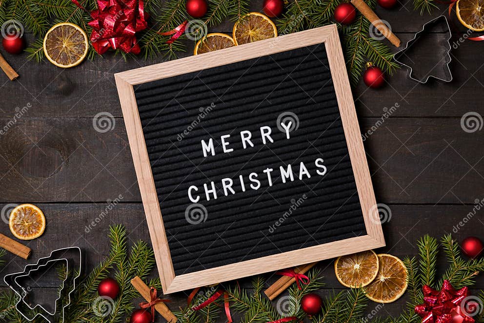 merry-christmas-letter-board-on-dark-rustic-wood-background-wit-stock