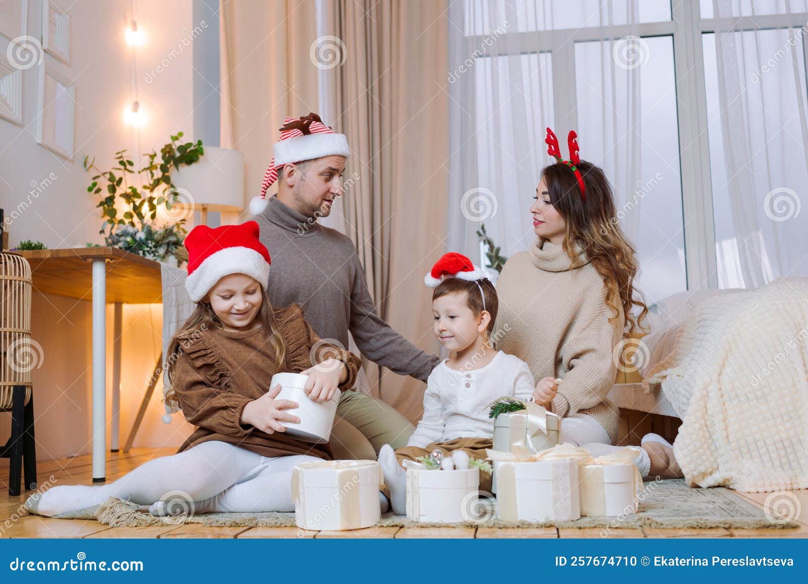 https://thumbs.dreamstime.com/z/merry-christmas-happy-holidays-cheerful-mom-dad-her-cute-daughter-son-exchange-gifts-santa-hats-parents-two-small-257674710.jpg
