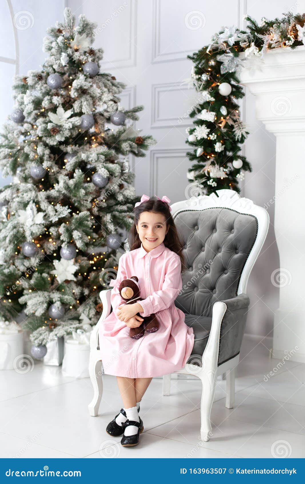 Merry Christmas And Happy Holidays! New Year 2020. Happy Little Girl In Dress Plays With Teddy ...