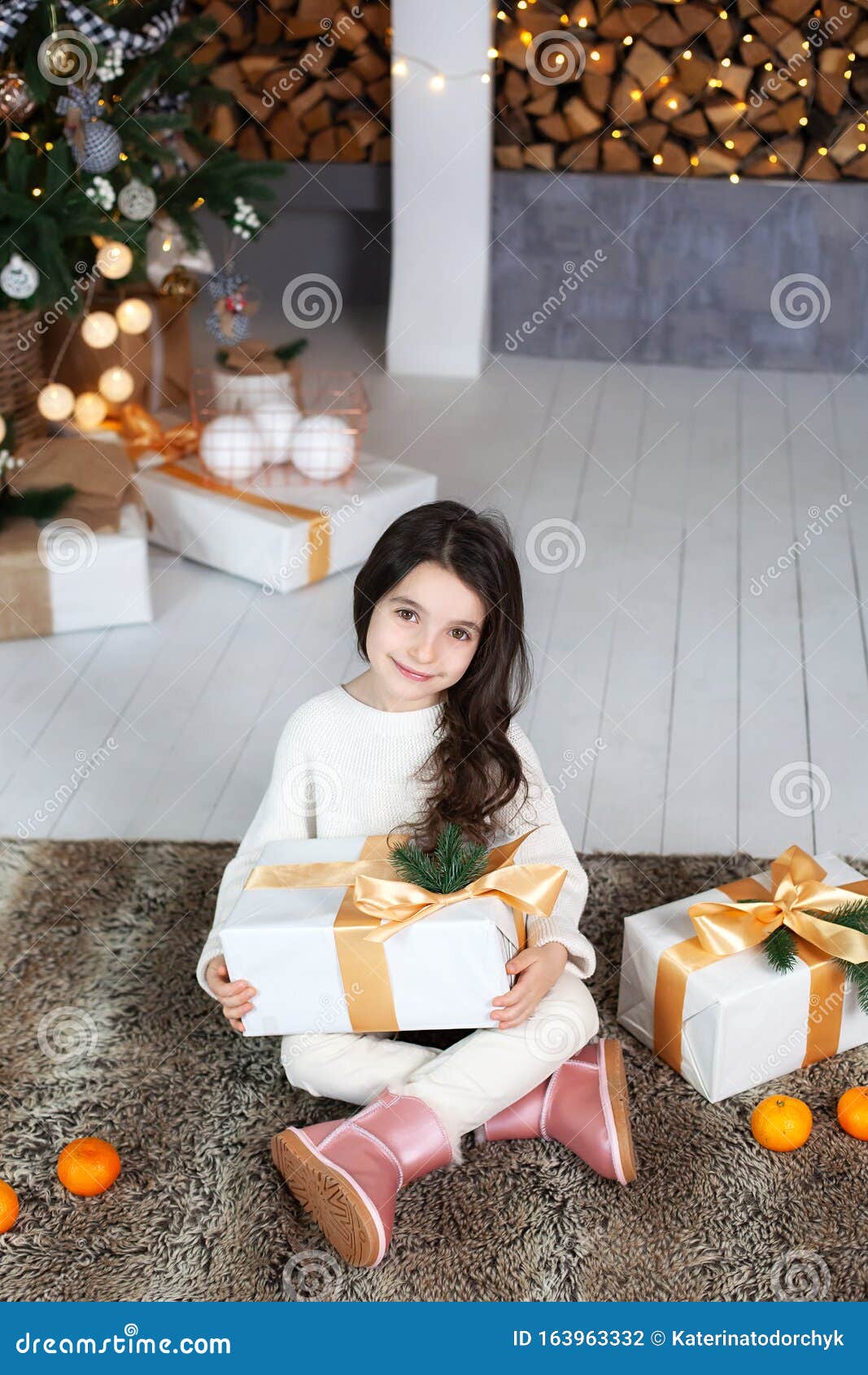 Merry Christmas Happy Holidays. New Year 2020. Little Girl In White Sweater With Gifts In ...