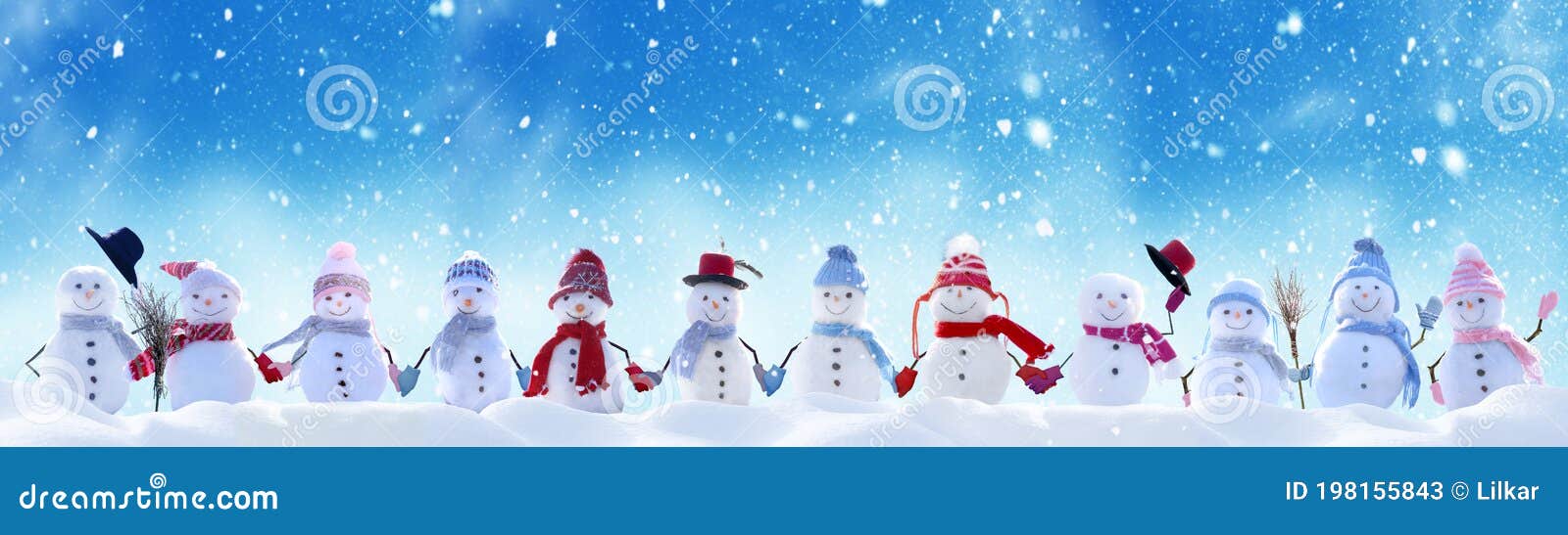 merry christmas and new year greeting card with copy-space.many snowmen standing in winter christmas landscape.winter