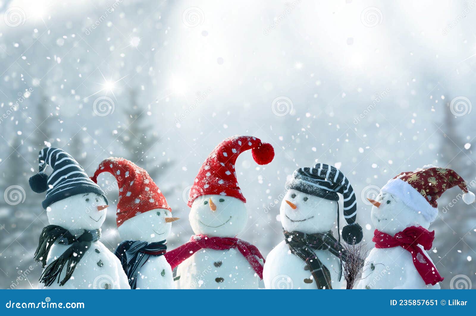 merry christmas and happy new year greeting card with copy-space.many snowmen standing in winter christmas landscape.winter