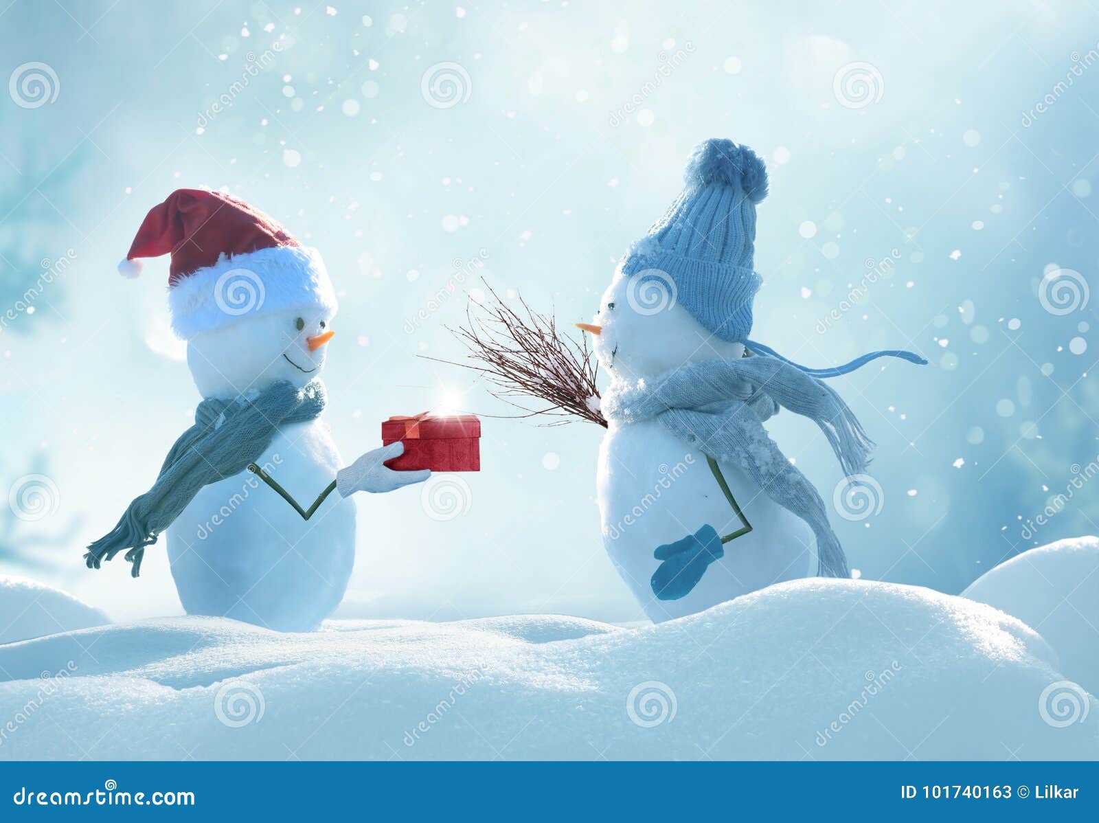two cheerful snowmen standing in winter christmas landscape.