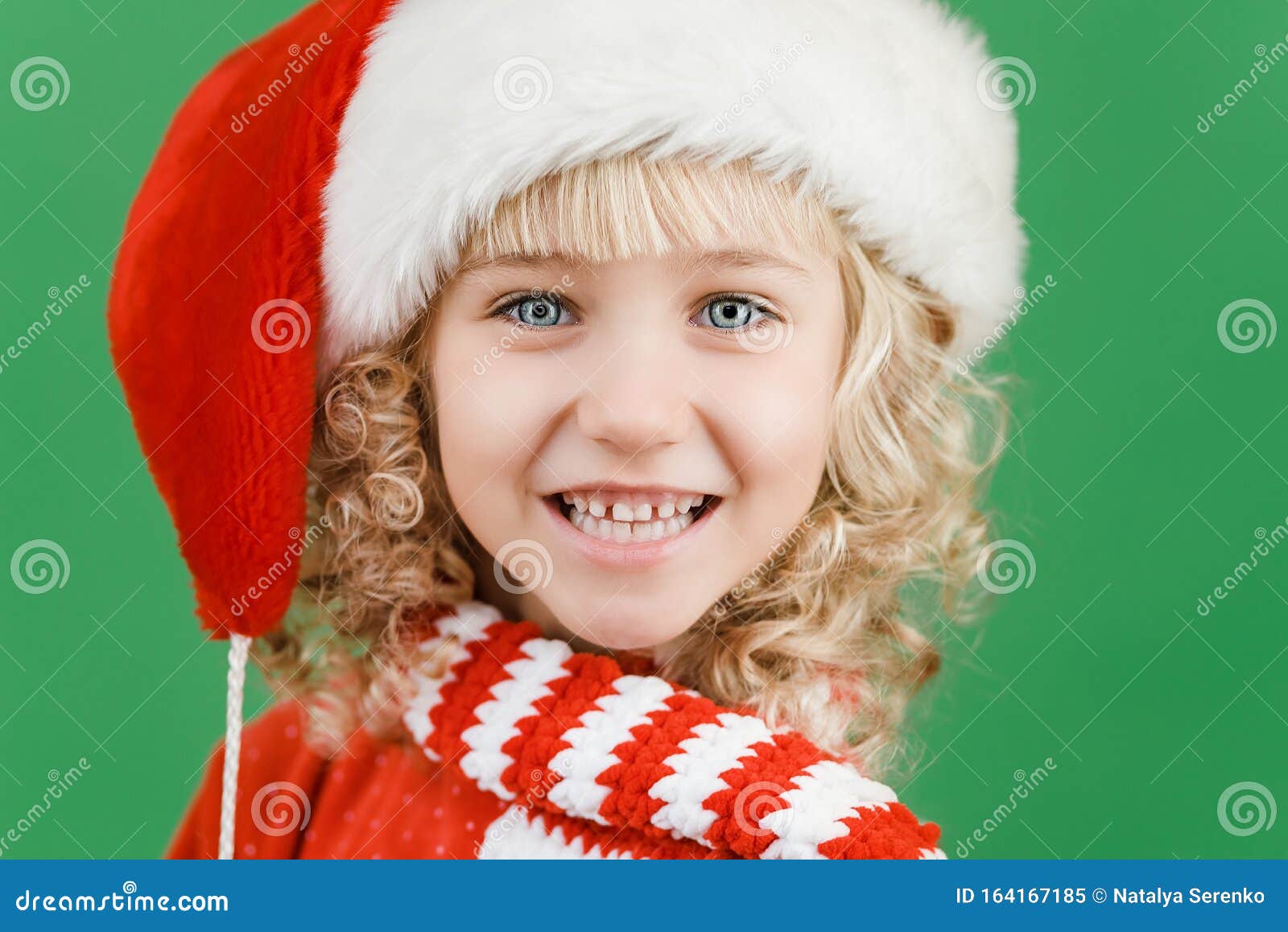 Merry Christmas Little Girl In Santa Hat On Bright Green Vivid Color