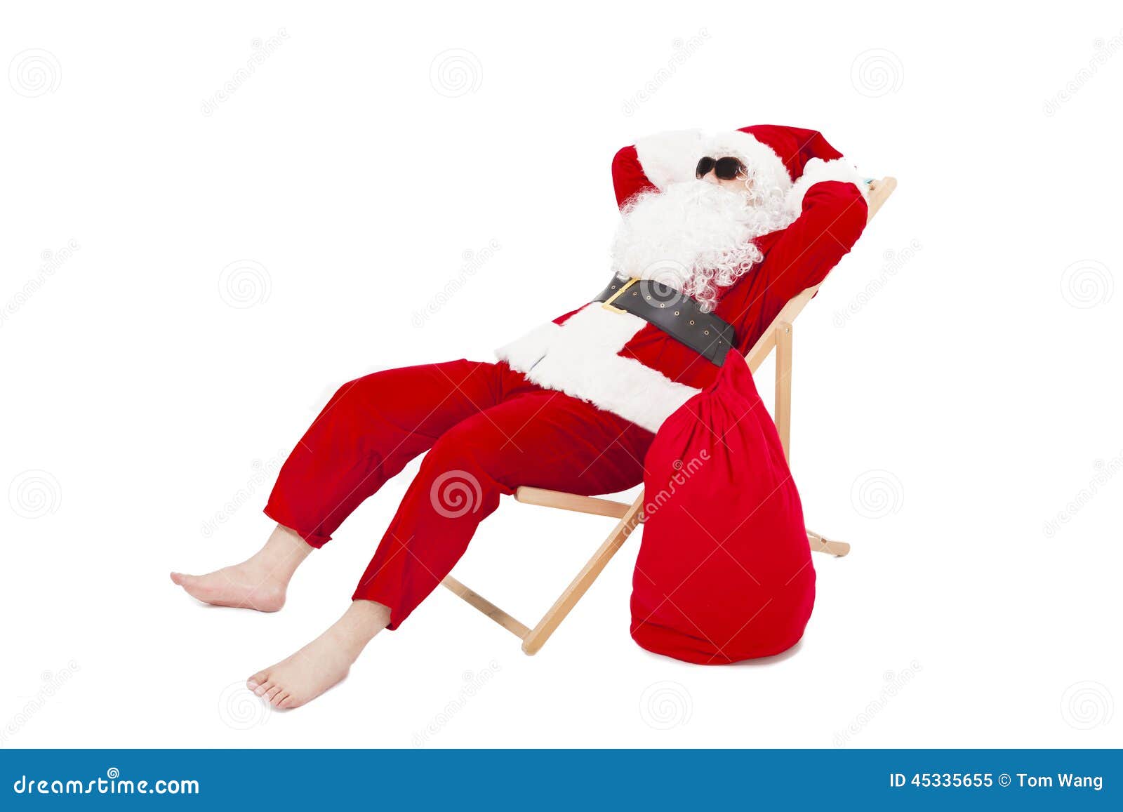 merry christmas santa claus sitting on a chair with gift bag