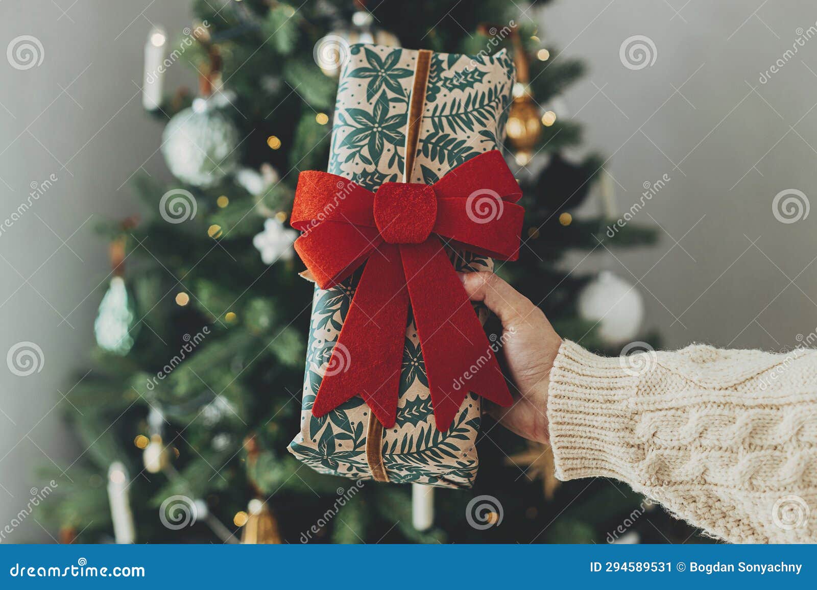 Wrapping christmas gift. Stylish festive wrapping paper, scissors, ribbons  Stock Photo by Sonyachny