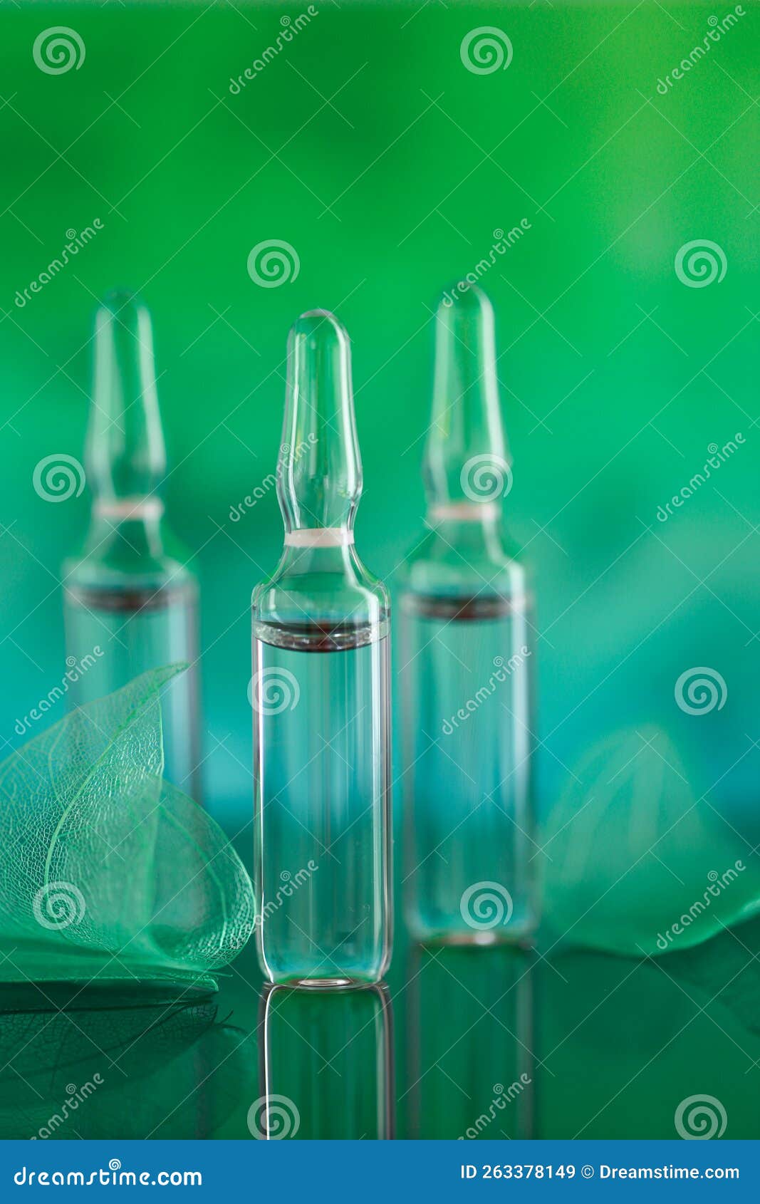 mesotherapy and dermabrasion serum in ampoules. cosmetic ampoules.beauty product.transparent ampoules and green
