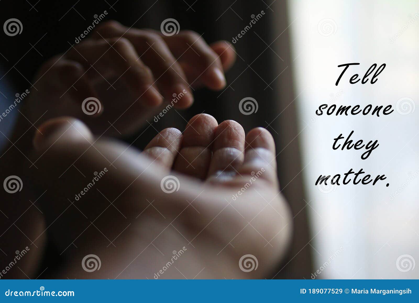 message on white background - tell someone they matter. with two hands showing kindness, love and care to each other.