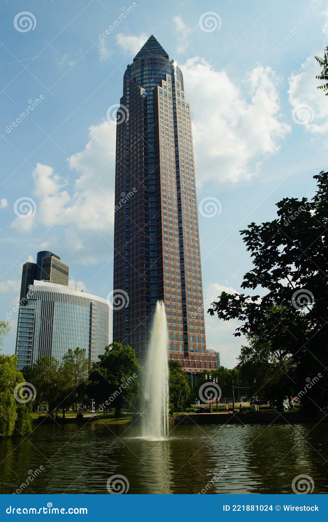 the messeturm rises behind a fountain.