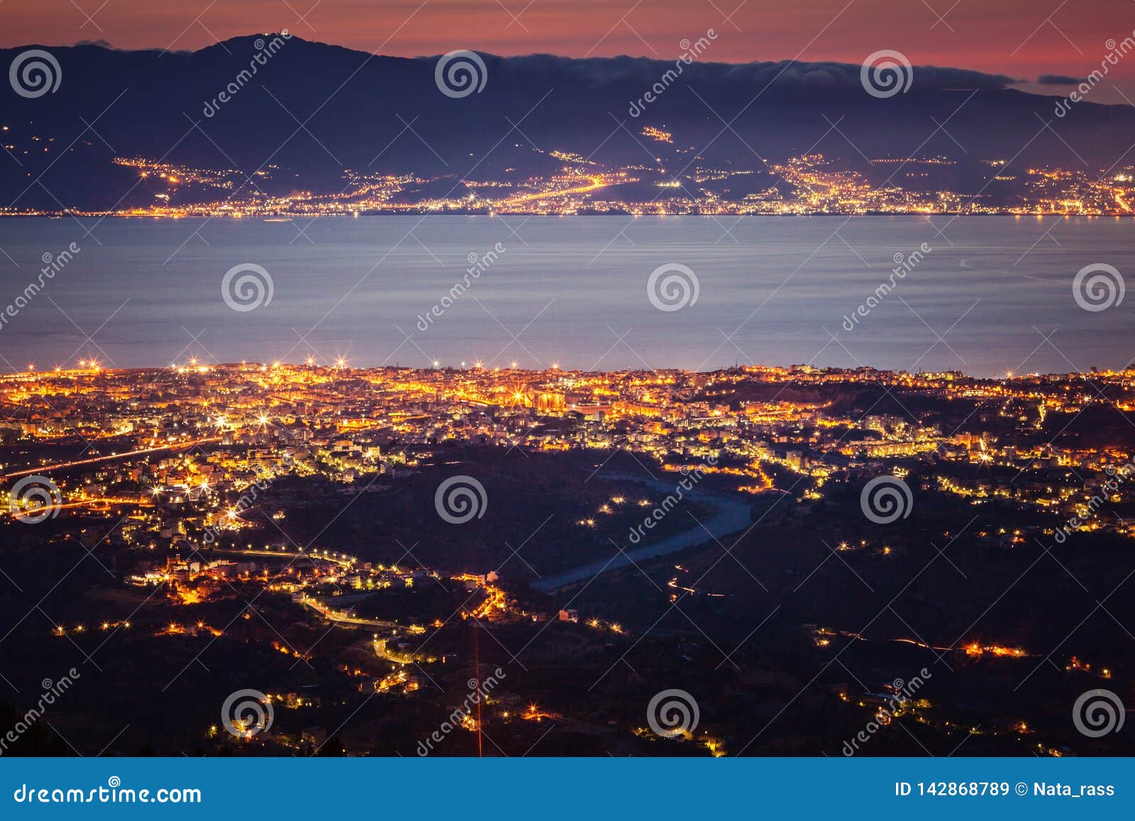 messina strait and reggio calabria city lights at dusk
