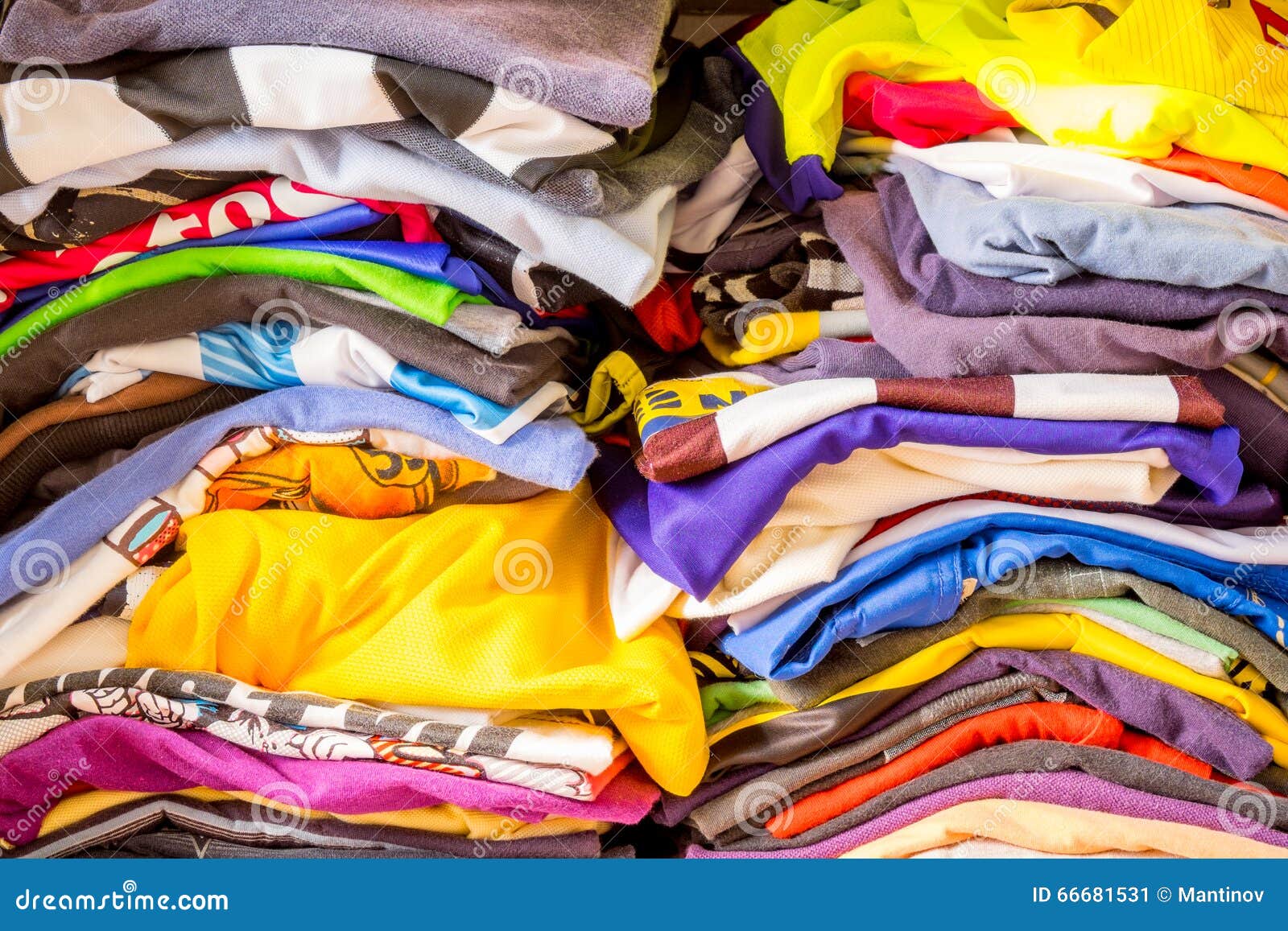 Messy Folded Clothes Crammed In A Closet On A Shelf. Depicting Woman`s