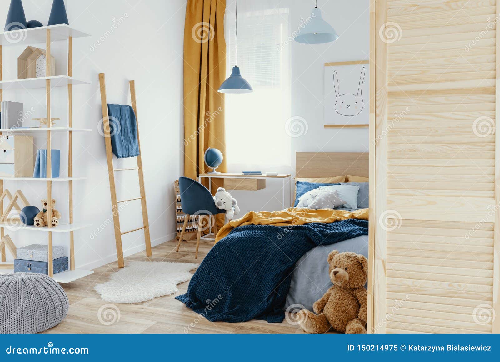messy kid`s bedroom with toys and wooden furniture real photo