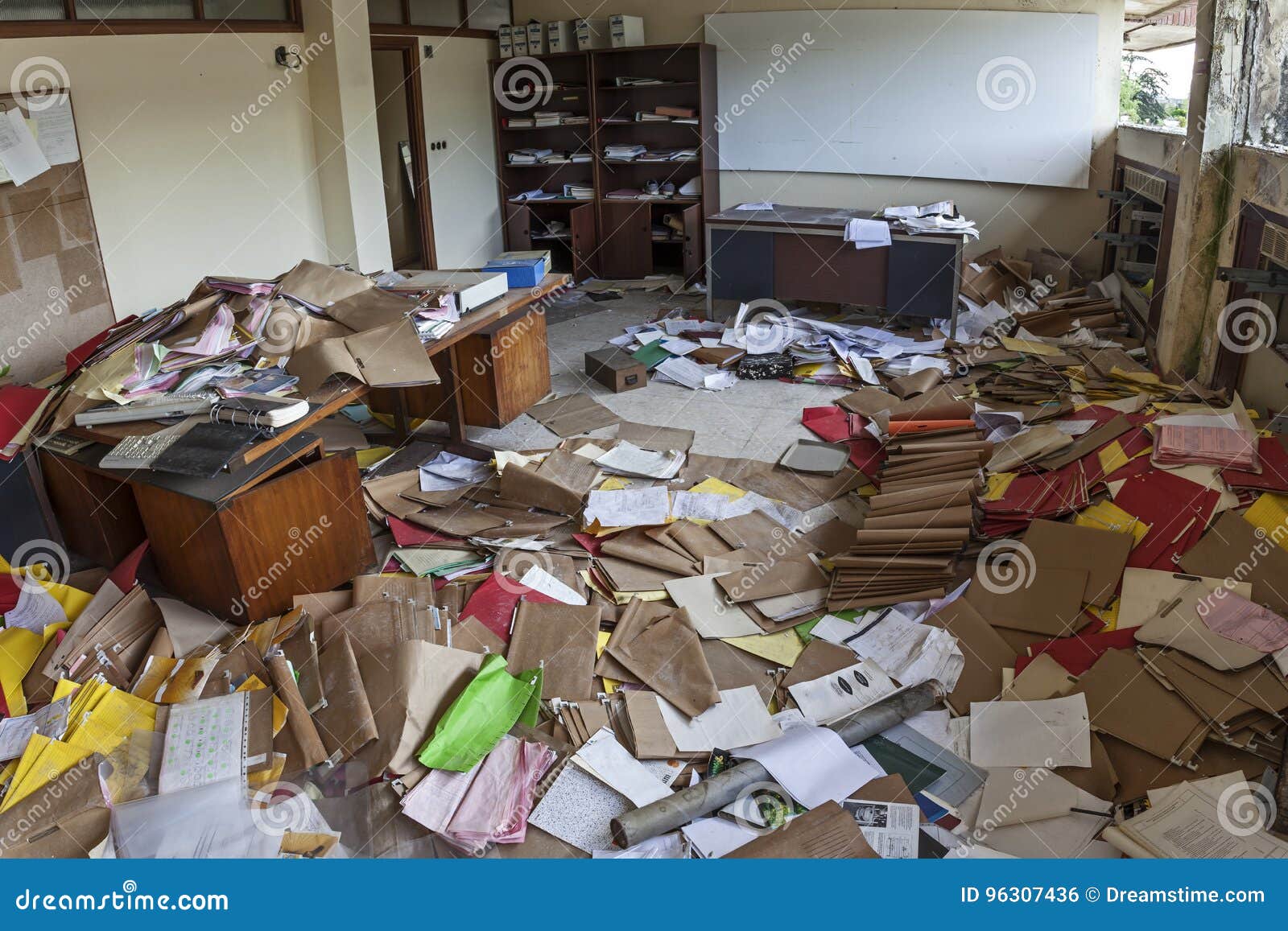 messy office full of folders and papers