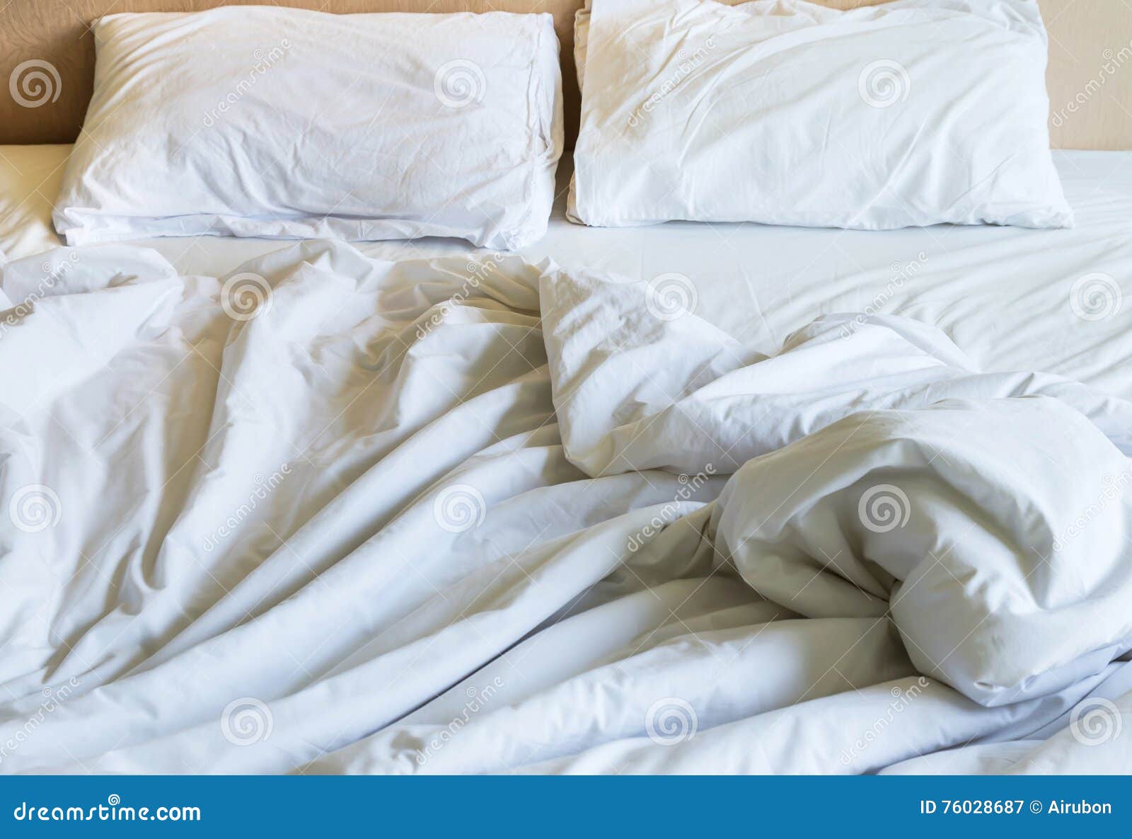 Messy White Bed Sheets and White Pillows after Waking Up Stock Image