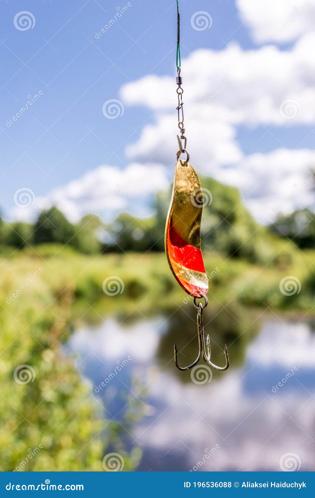 Metal Bait for Fishing/shine for Fishing Hangs on a Fishing Line Against  the Background of the River Stock Photo - Image of metallic, gear: 196536088