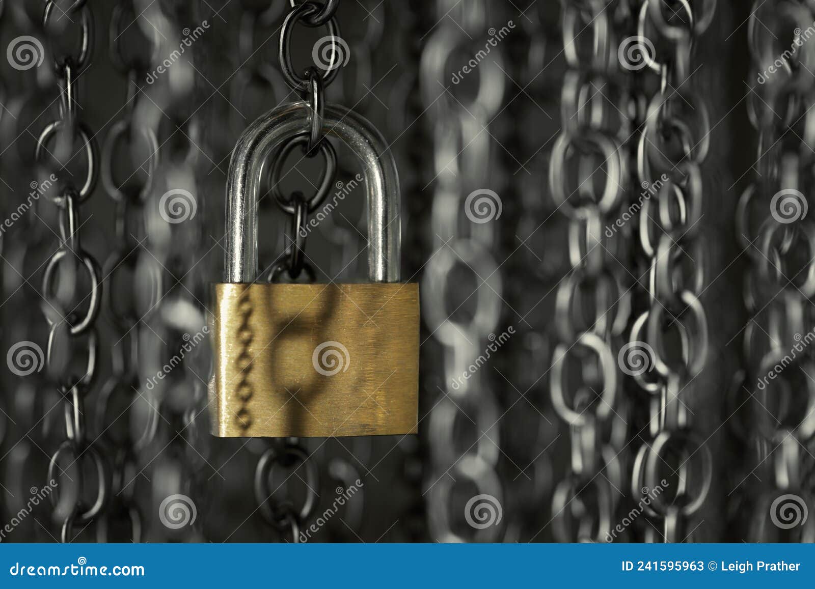 metal chains hanging vertically with a shiny lock. business data encryption, home security, or other safeguarding metaphor