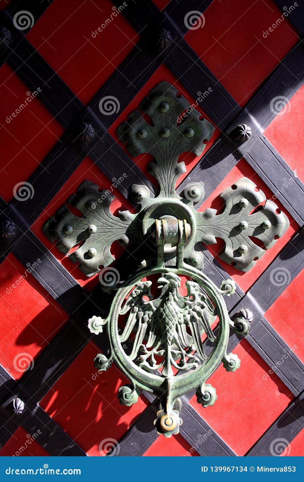 Ironcast Door Knocker with Eagle on the Red Door. Stock Photo Image