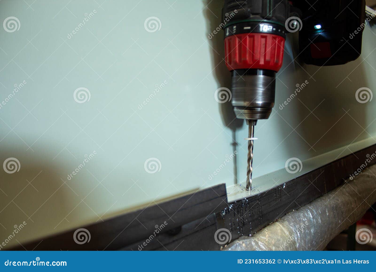 Metal Drilling Closeup in Metal Drilling Machine Making a Hole in a Steel Bar Stock