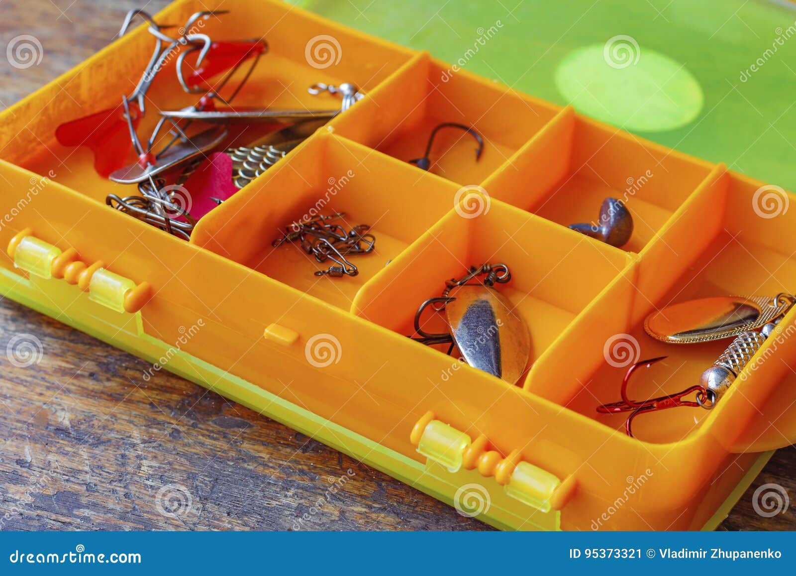 Metal Fishing Baits in a Orange Plastic Storage Box Closeup Stock Image