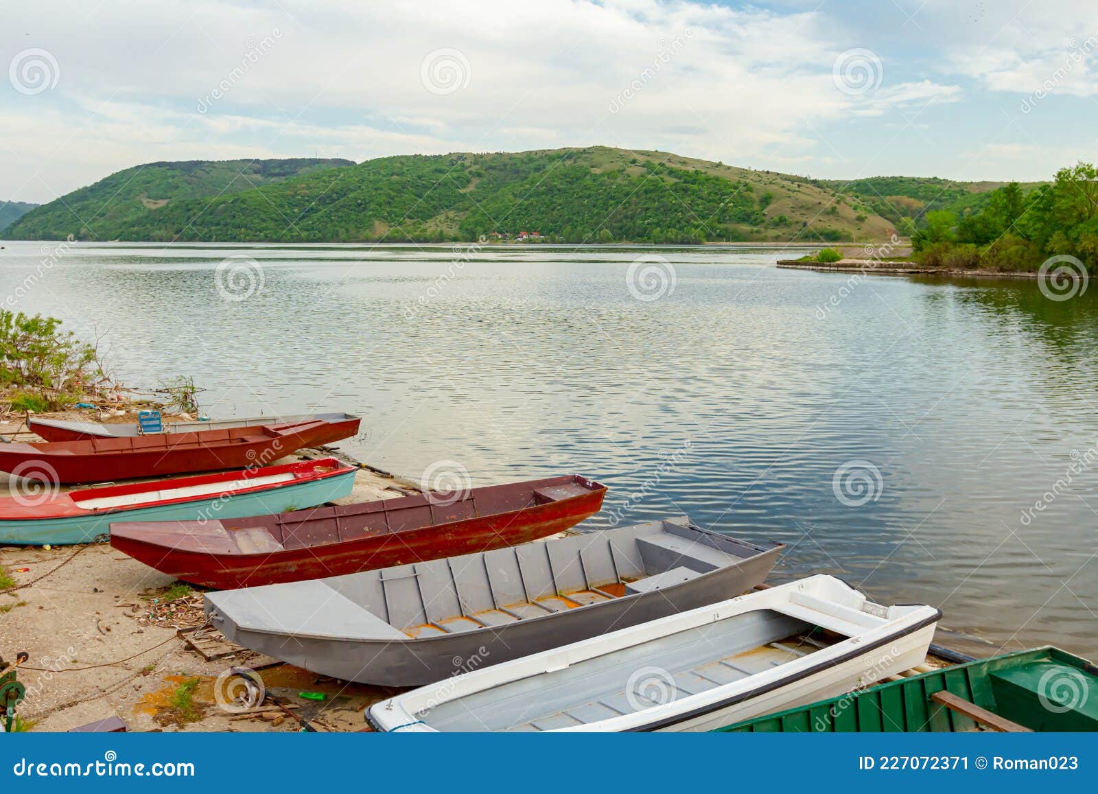metal fishing boats are dry docked above water