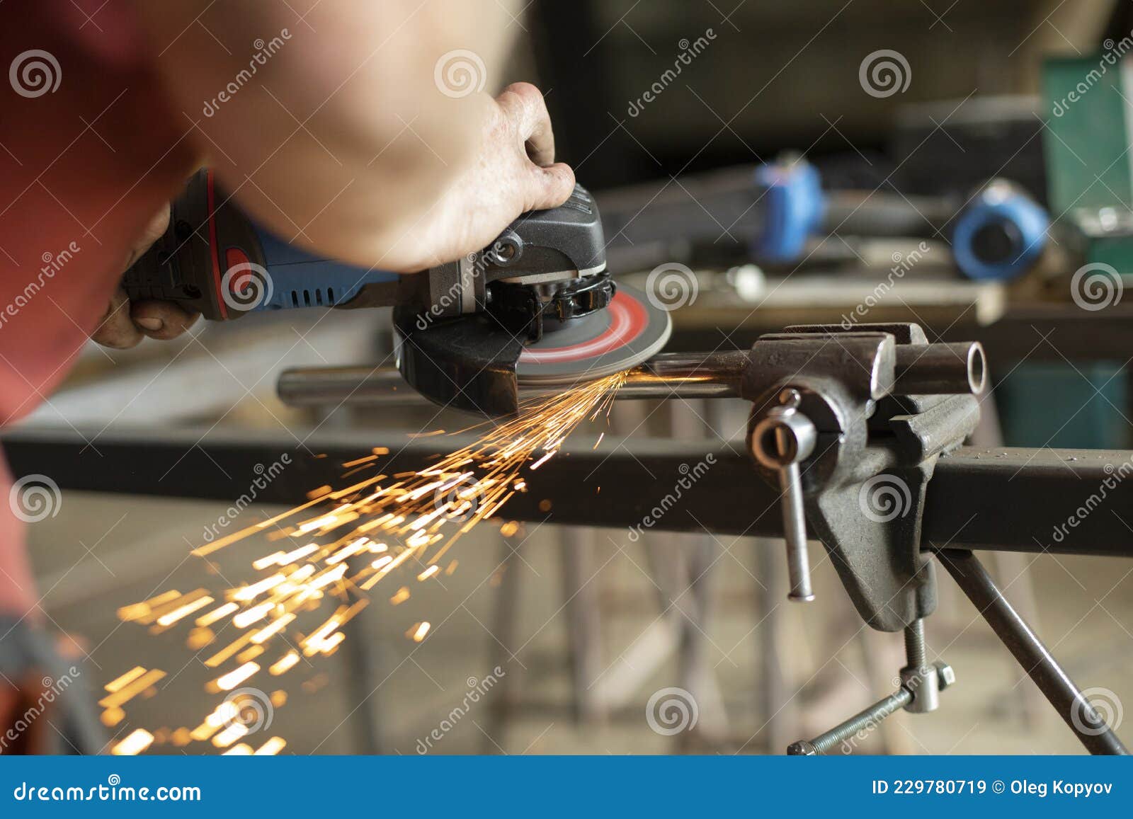 A Man is Working on a Part in the Garage.Metal Grinding. Steel