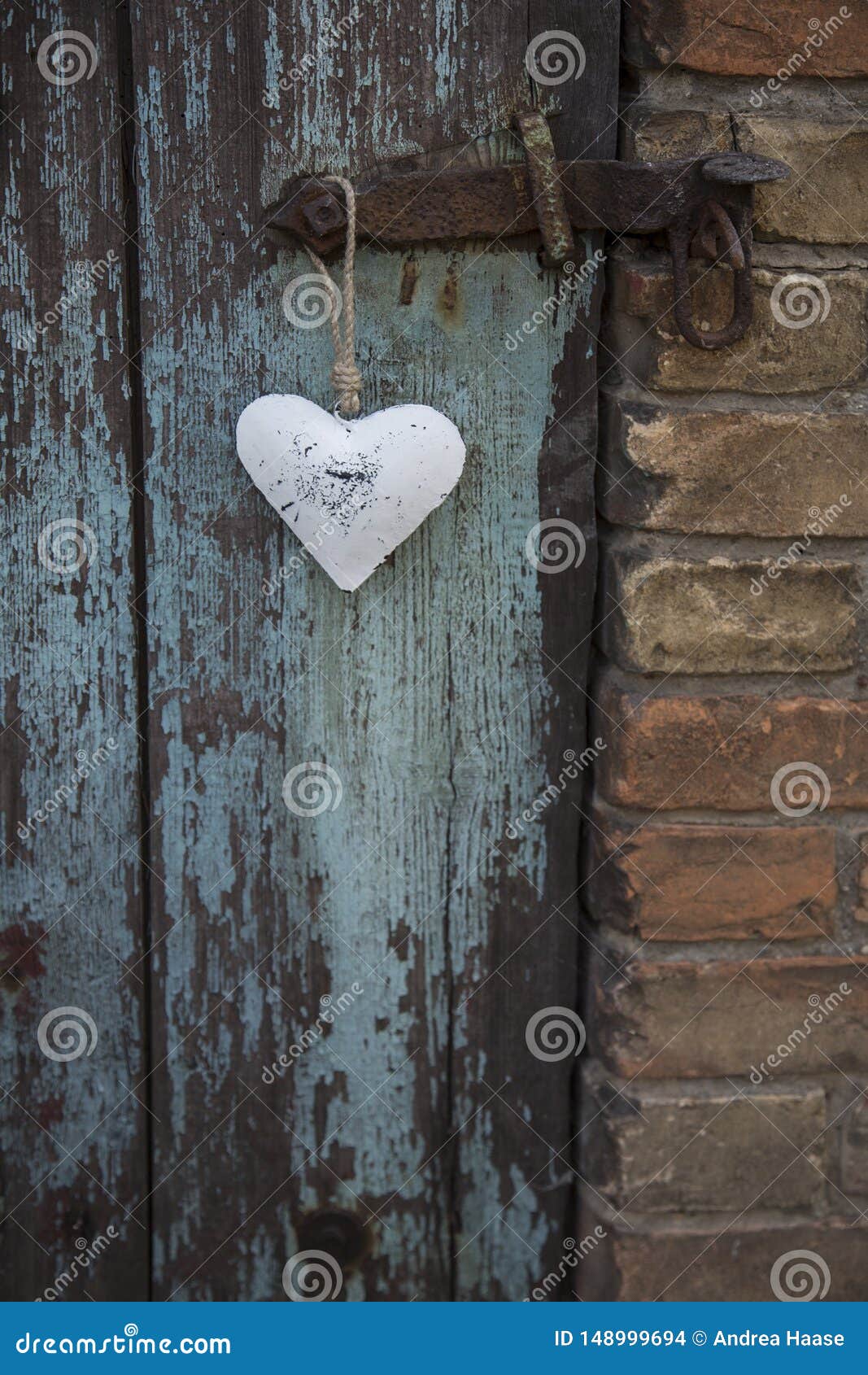 metal heart hanging on old door handle