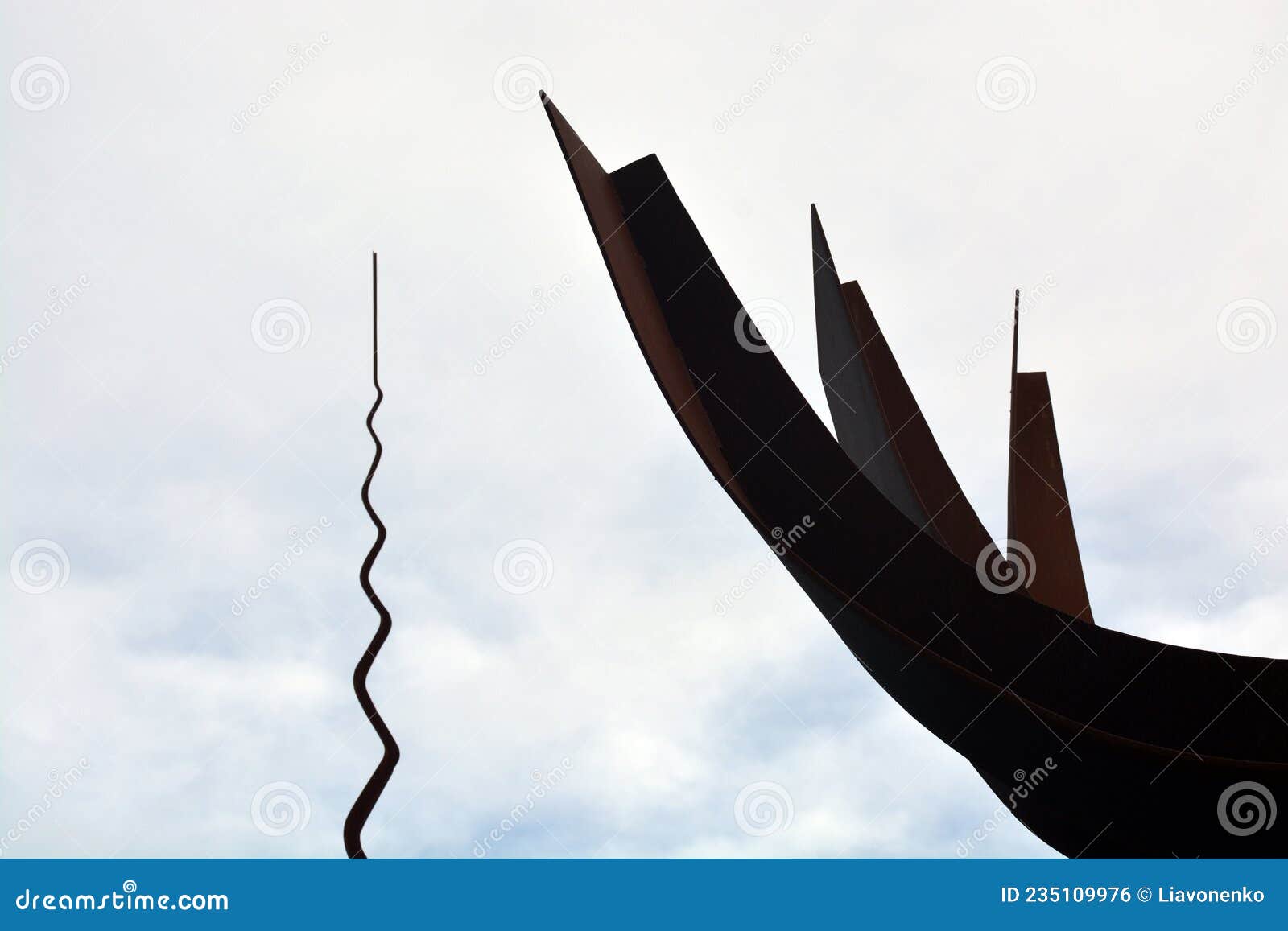 metal monument. on the sky background. peace park almada portugal. monumento de ferro. parque de paz. cÃÂ©u nublado.